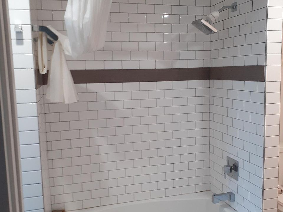 Bathroom with ceramic tile and modern bath/shower.