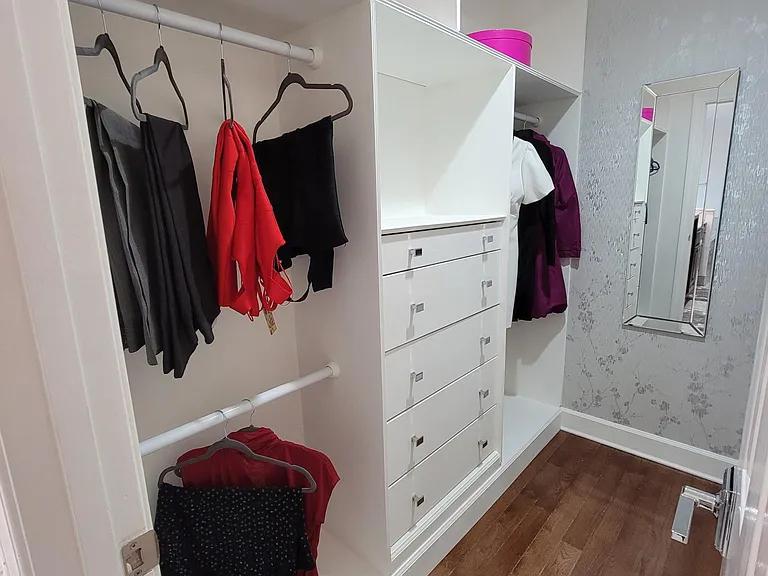 Primary bedroom walk in closet