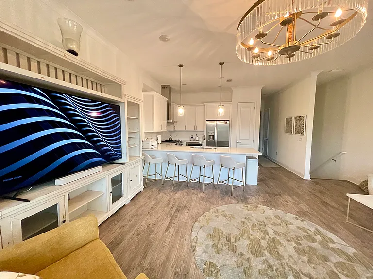 Living room with kitchen, hallway with half bath towards the Master Unit with private balcony.
