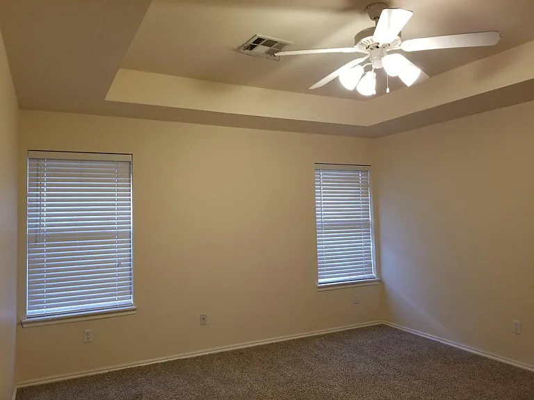 Master bedroom with trayed ceiling.