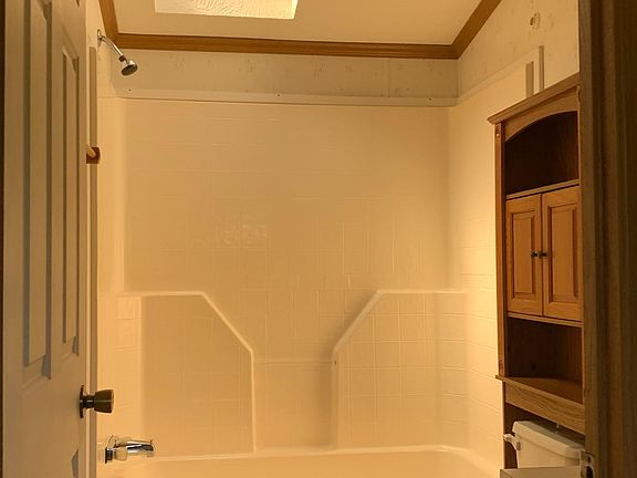 Guest bath room with skylight and oak storage hutch