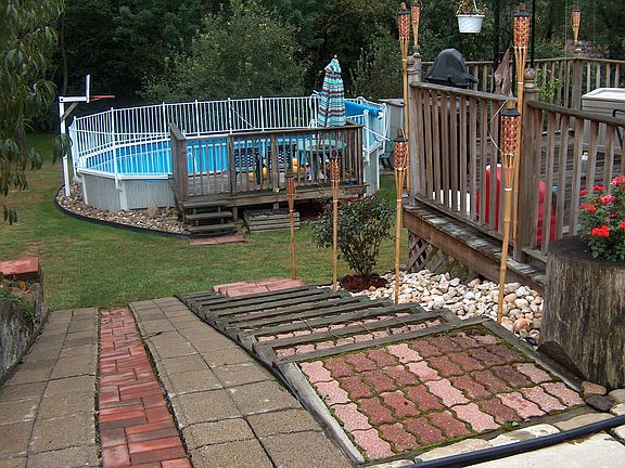 Well landscaped yard that goes beyond the pool area