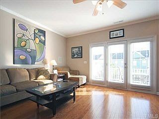 Living room is spacious. Nine-foot ceiling. Wall of windows.