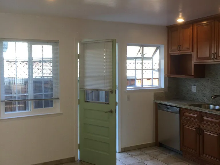 tile floor in kitchen, recess lightings on ceiling, door open to patio