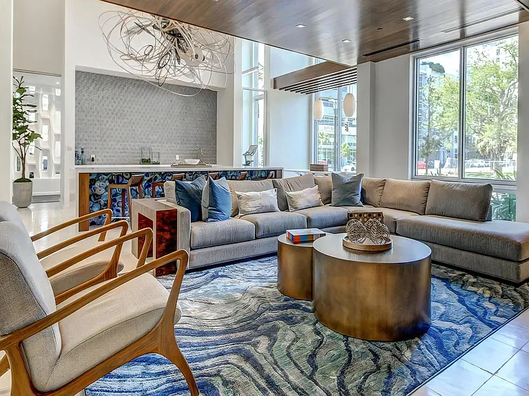 Large Lounge Space With Sectional Sofa and Window Views to the Street