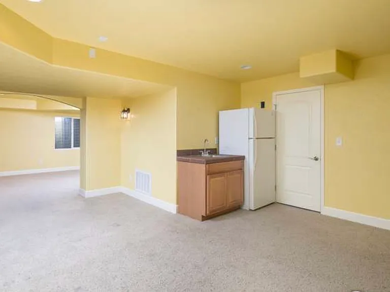 Large finished basement with sink and fridge