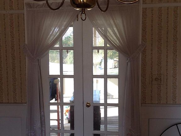Doors off dining room onto screened in porch.