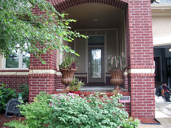 Brick & stone portico set the tone of the elegant home.