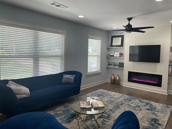 Living room with gas fireplace and embedded Bluetooth speakers in ceiling