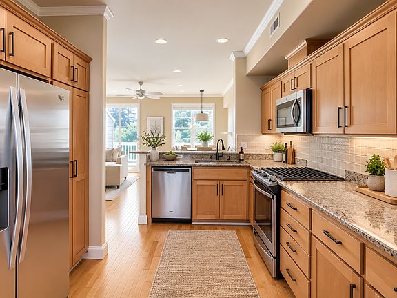 Kitchen - stainless steel appliances, gas range, granite slab countertops.