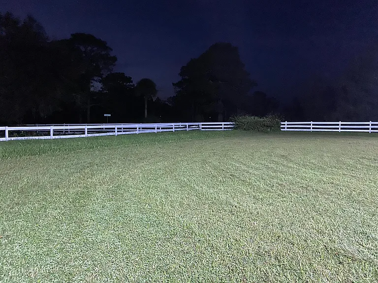 Riding arena at night. It has 4 new 400 watt LED lights. It is a rectangle for dressage and extra wide, no footing.