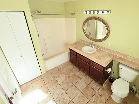 Pictured: Main level bathroom

Also on this floor: 
Kitchen
Dining/Living (18'x13')
1 Bedroom (13'x10')
Garage access
Deck access
Stairs to top/bottom floors