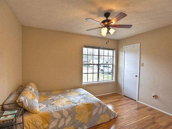 This secondary bedroom has a nice updated ceiling fan/light, a spacious closet and a large window overlooking the front yard.