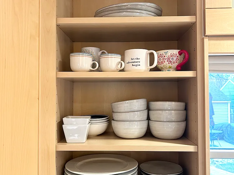 Fully stocked kitchen with plenty of plates, bowls, mugs, etc.