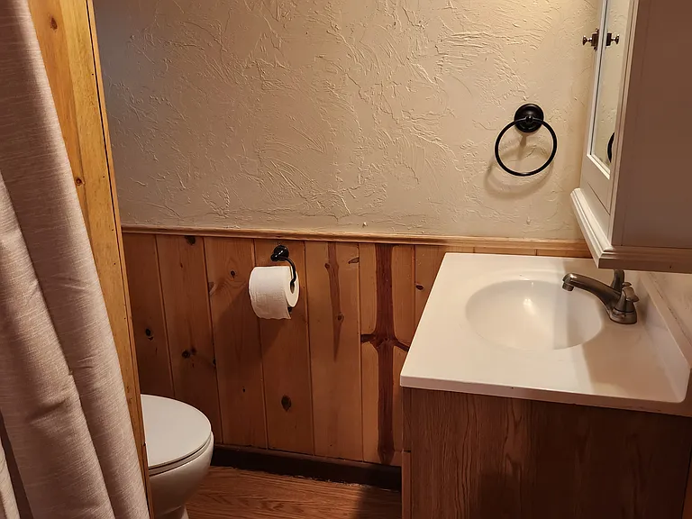 Peaking into the Bathroom with a good sized Vanity. The bathroom has a pocket door for privacy.