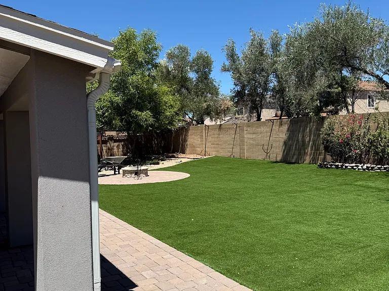 Extended pavers outside the covered patio are perfect for BBQ. Propane tanks for that, kitchen stove and front yard fire ring are against the east wall