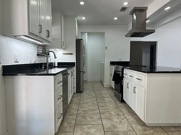 Kitchen and Dining Area with recessed lighting, granite countertops, induction stove, and hardwood cabinets