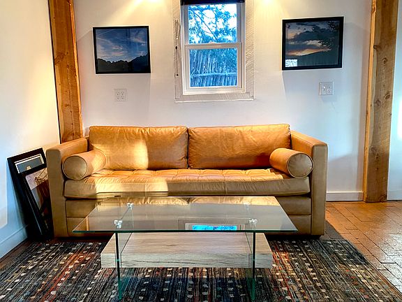 Downstairs Sitting Area with Leather Couch and Coffee Table