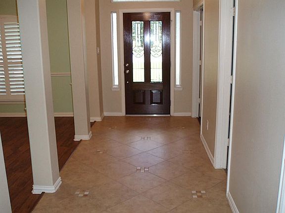 Main living room to front door. Dining, full powder bath, storage on left and study on right.