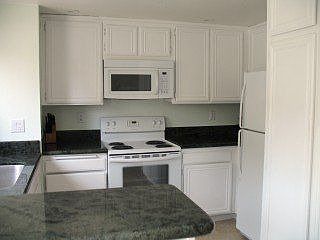 Kitchen with Granite slab counters