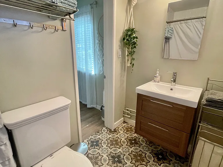 Full bathroom with tub/shower and hairdryer, which is attached to the Master Bedroom