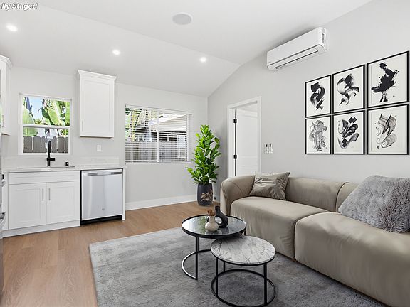 Living room area has an open feel with bright and cheerful windows and lighting. High ceilings throughout and no carpet.