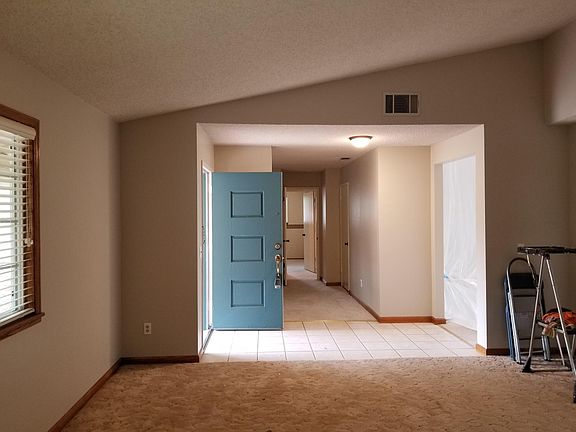 Living room looking into entry and 4th bedroom