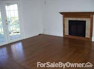 Living Room : Fireplace, wood floors, and french doors!