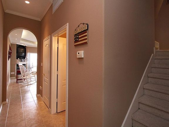Entry hall.  Stairs on the right lead upstairs or go forward to living area.
