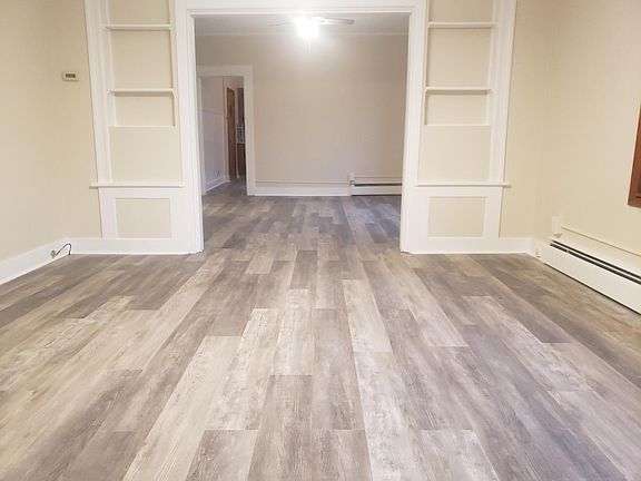 Center of living room, entrance is on the left, dining room is ahead.