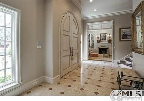 Large custom double doors welcome you into the home