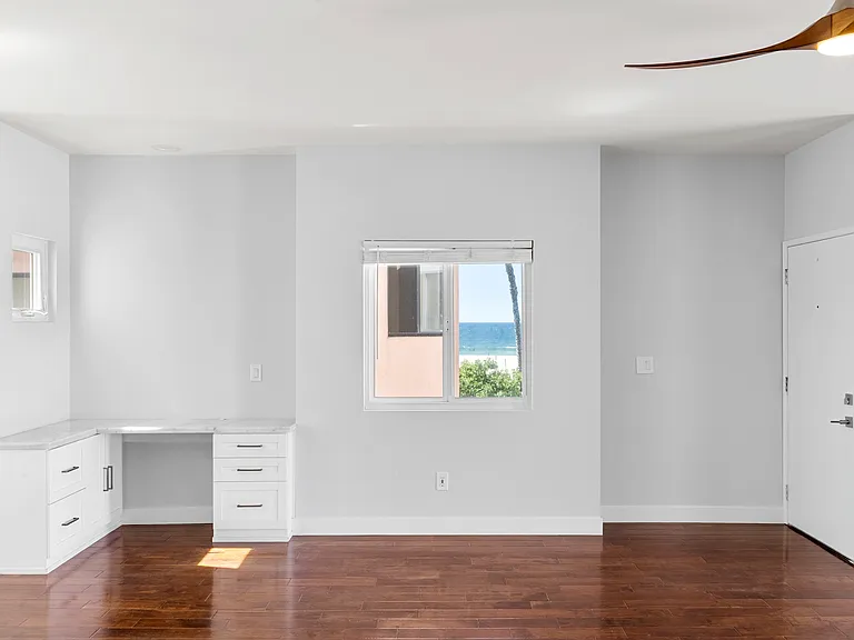Desk and view of the ocean from the living room with front door