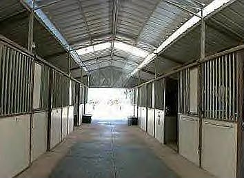 TURNKEY BOARDING FACILITIES INCLUDE 8 STALL SHOW BARN WITH TACK ROOM & OFFICE.