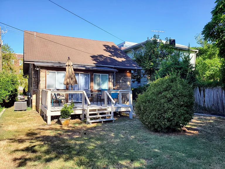 Large backyard with deck. Off street parking is next to the backyard.