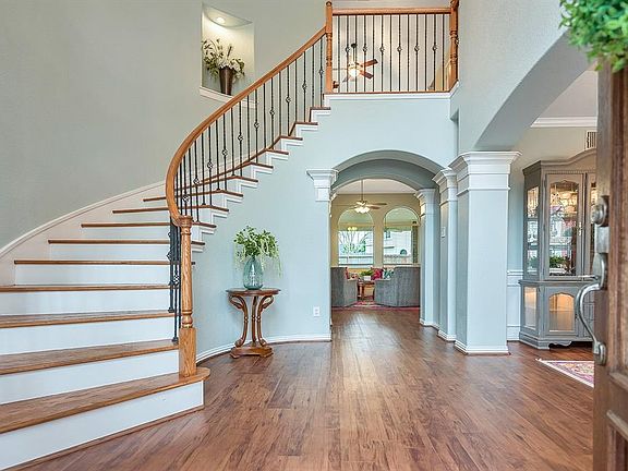 Grand entry hall with high ceilings and spiral staircase greets you and your guests as you step inside. Stunning floors, wooden stairs with iron balusters, and classic crown moldings make this home a show stopper. Dining Room to the right, Family Roo