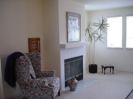 Formal living and dining roons warmed by gas fireplace