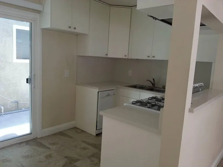 Kitchen with white cabinets and stone countertop