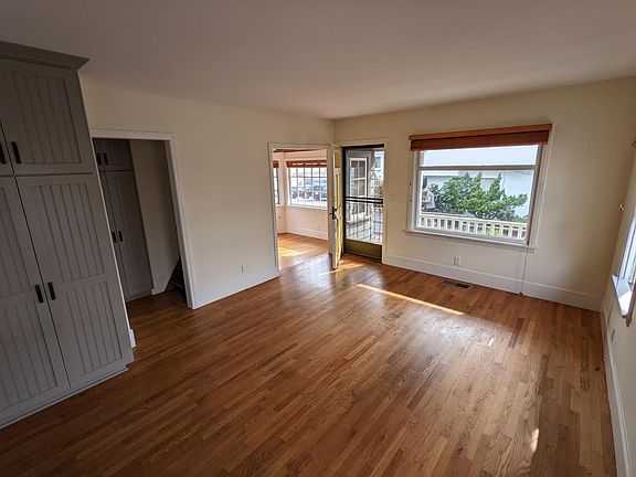 Living room. Stairwell to tower room, step down into front dining area/den/or office