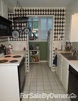 Galley Kitchen and Laundry
						:
						Galley kitchen adjoins dining rm & laundry area w/refr that conveys.