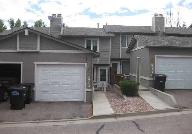 Front of townhouse includes one car garage