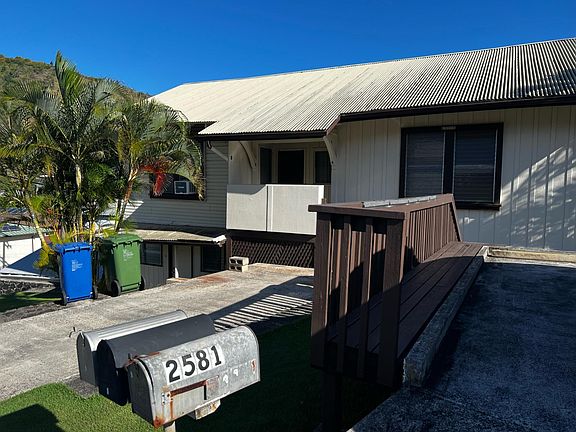 outside - unit B (with a/c unit showing) is to the left - shares porch entry with A. Parking for unit B.