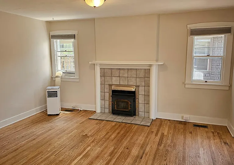 Living Room with Restored Flooring and Fireplace