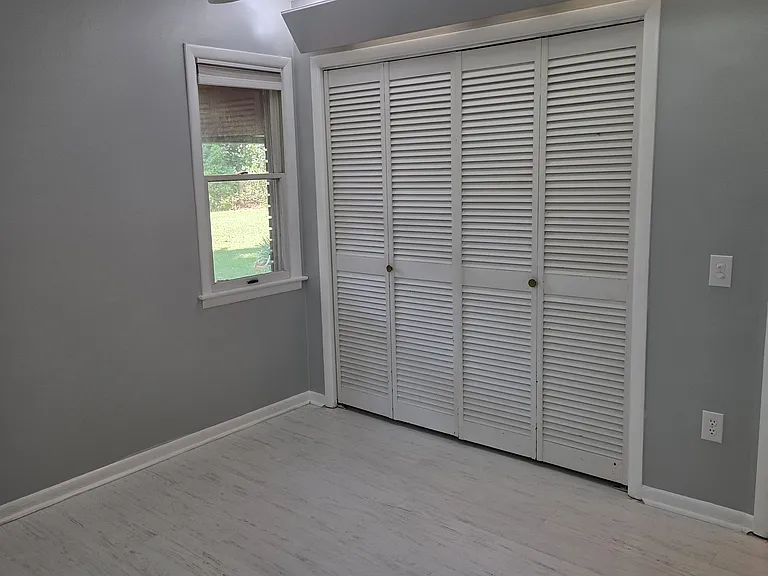 3rd bedroom showing large closet along the wall behind bi-fold doors