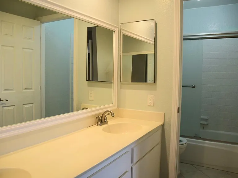 Toilet and shower are in a separate room with a door.