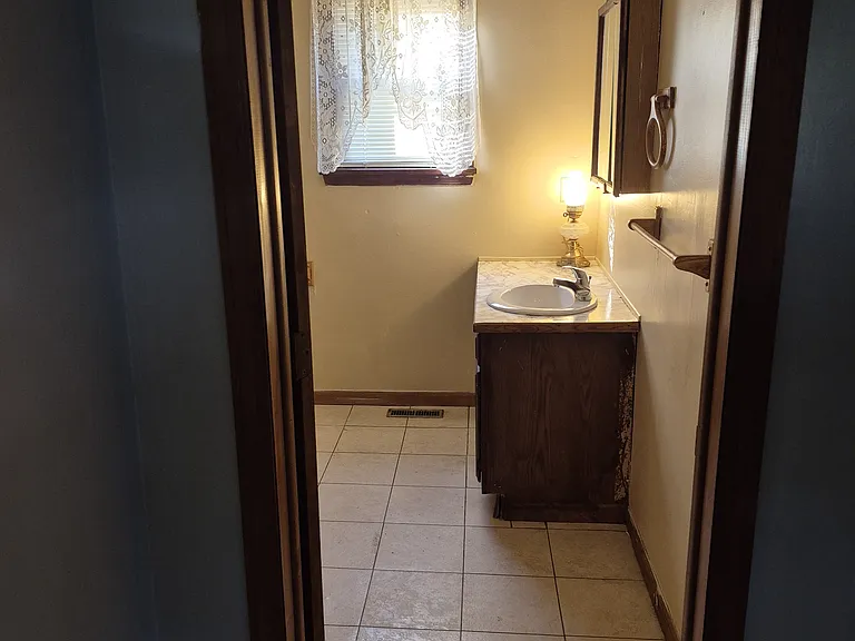 view bathroom sink from kitchen doorway
