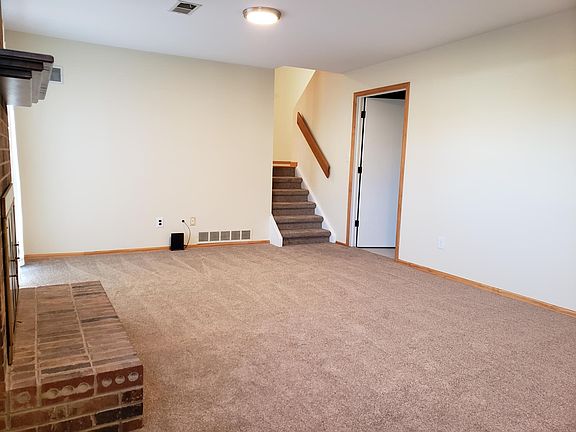 Family room, looking at stairs to kitchen and door to full bath and laundry room