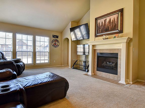 Spacious living room complete with soaring ceiling, built-in TV nook and wall of windows for abundant natural lighting overlooking the spacious backyard.