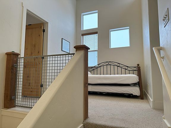 Stairs leading up to the open space between the two bedrooms.