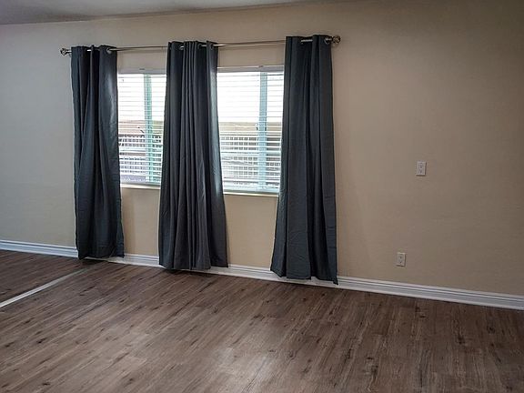 living room windows with new blinds and blackout curtains