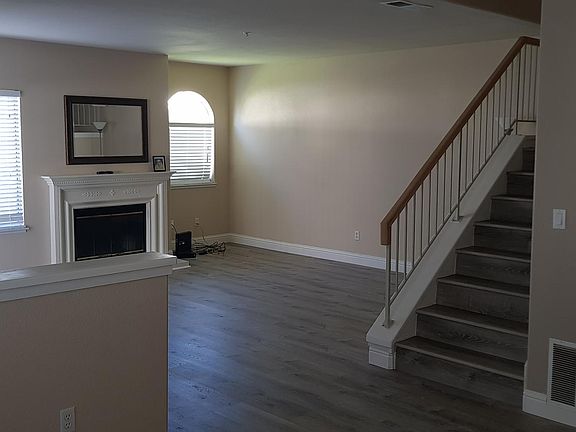 Family room with hardwood flooring & wood fireplace
